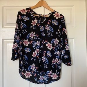 Black floral blouse with a criss-cross v-neck